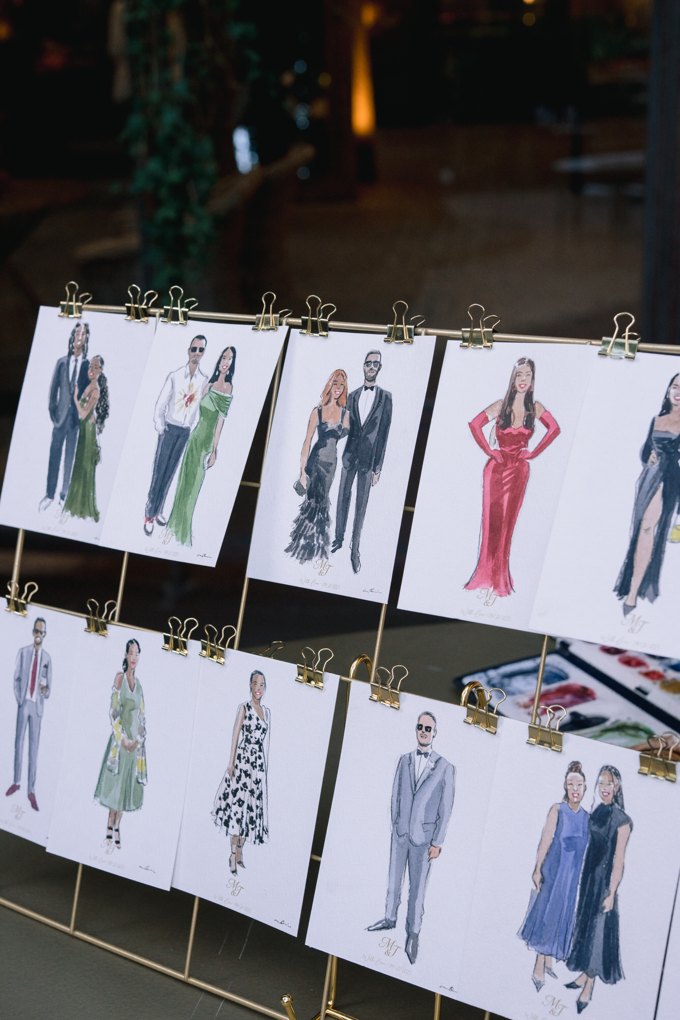 Illustrated portraits of the guests displayed on gold easels as part of the seating plan