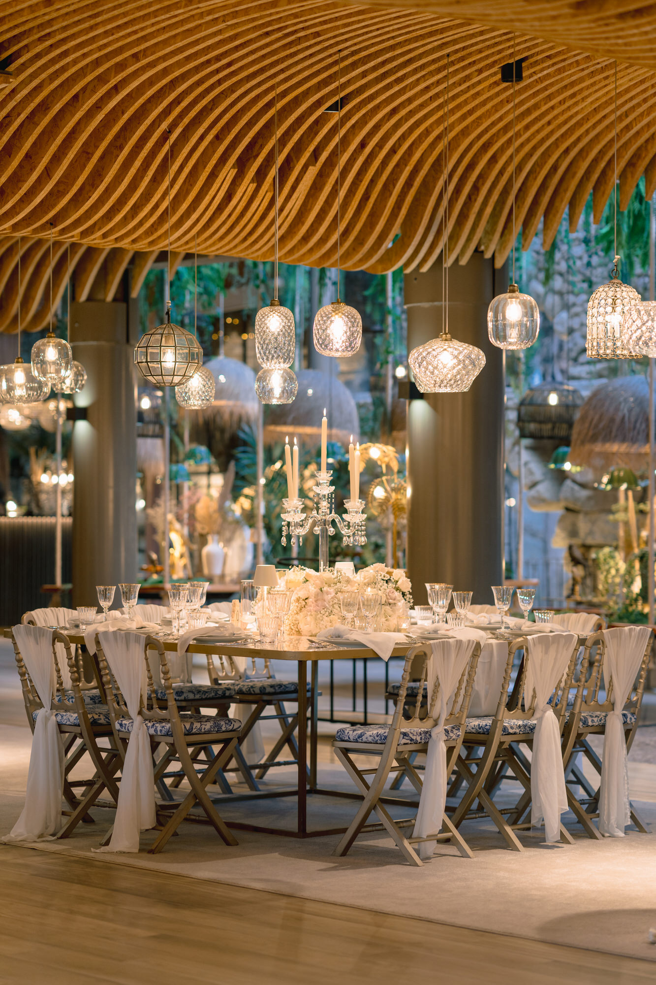 The reception under a wooden canopy, a round table set among hanging lanterns