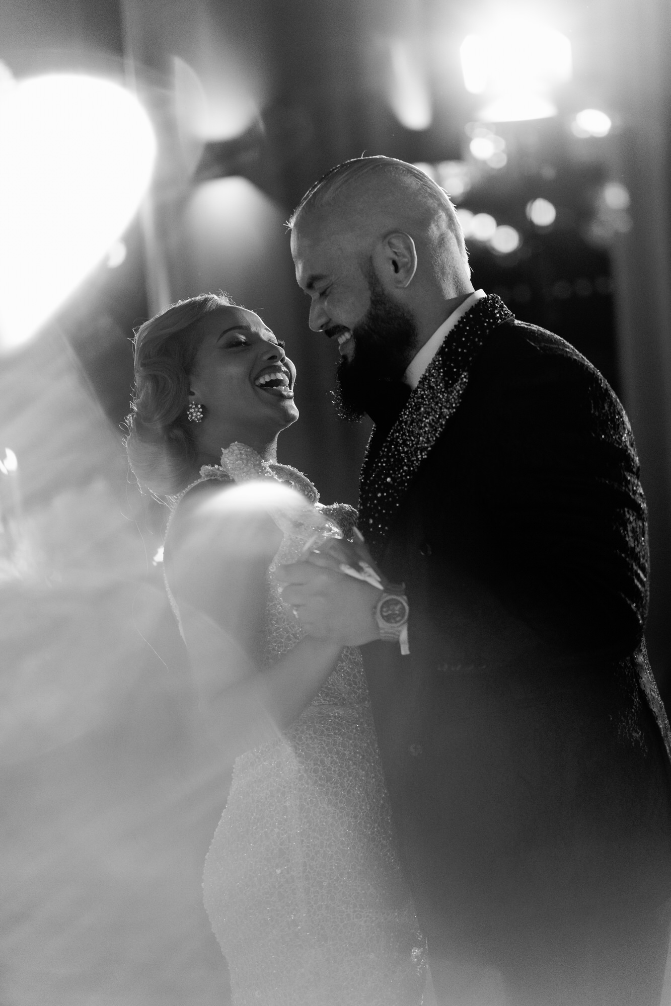 Black-and-white image of the couple dancing close, foreheads almost touching